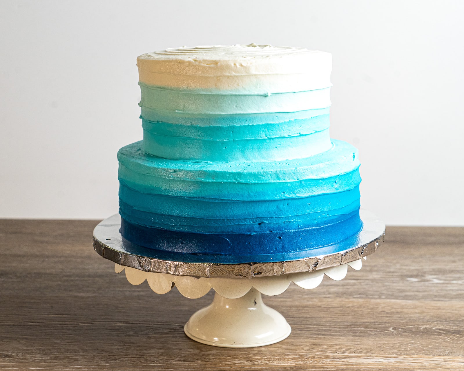 This double-height, stacked cake (10" and 8" cakes) features elegant blue ombré buttercream frosting.